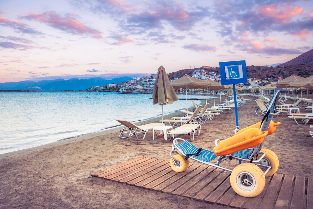 Beach,Wheel,Chair,For,Disabled,Swimmers,,Elounda,,Crete,,Greece. vozik na plazi, kreta