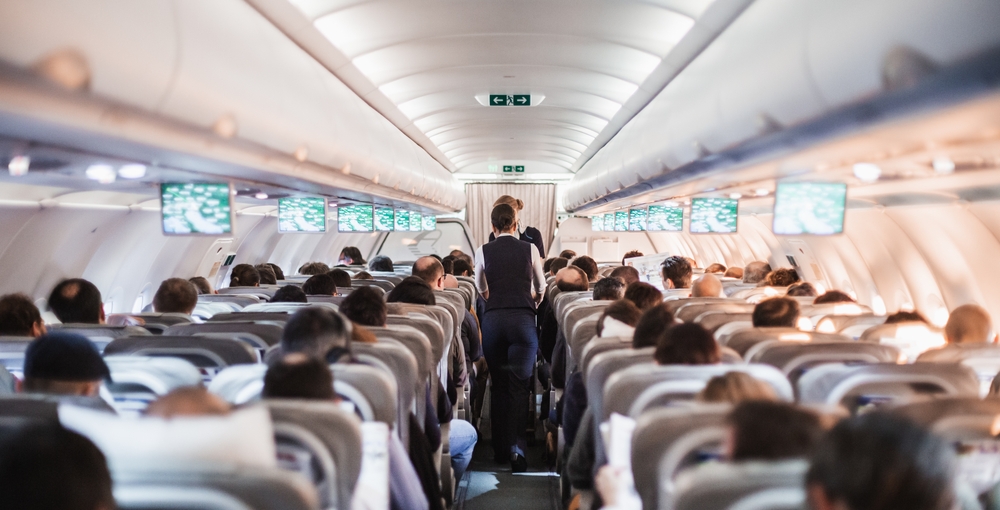 Interior,Of,Airplane,With,Passengers,On,Seats,And,Stewardess,In Skupinové letenky cez Pelikán: cestujte spolu komfortne a s výhodami