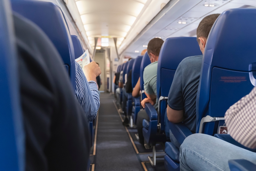 Passage,In,The,Plane.economy,Class,Interior,,Aircraft,Cabin.,Passengers,Sit pasazieri sediadi v lietadle